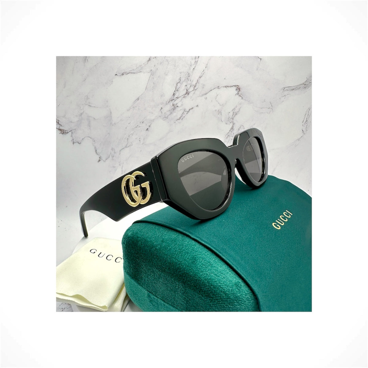 Gucci GG1421S 001 women's black rectangular cat eye sunglasses with gold GG logo
