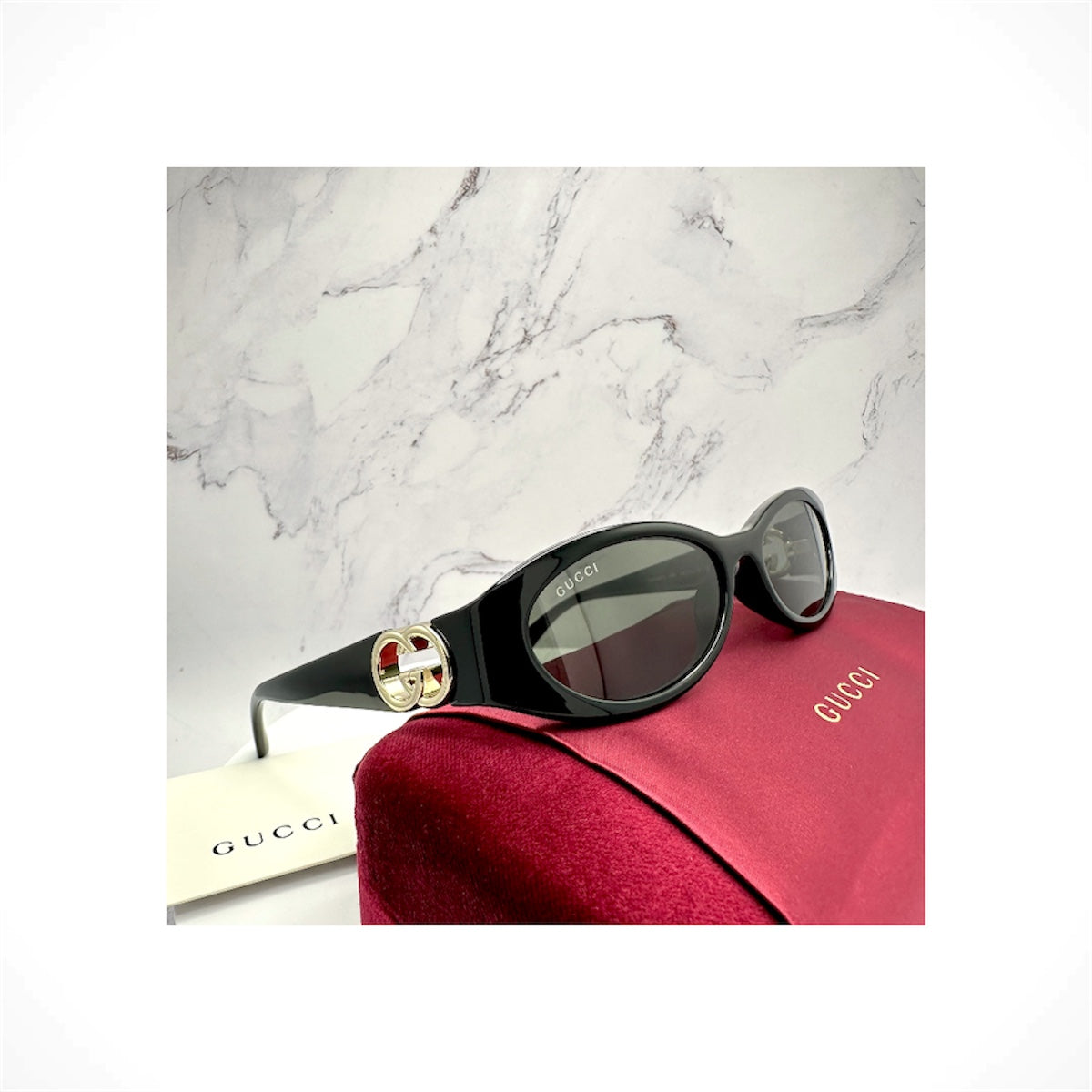 Gucci GG1660S 001 women's black oval sunglasses with gold GG logo