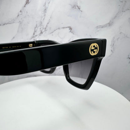 Gucci GG1714S 001 black sunglasses side view of temple arms with gold interlocking GG logo.