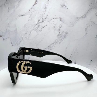 GUCCI GG1422S 001 side view of black arms with gold metal logo.