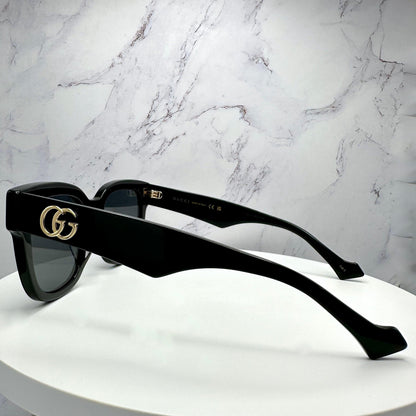 Gucci GG0998S 001 black square sunglasses with gold metal GG on temple arms.