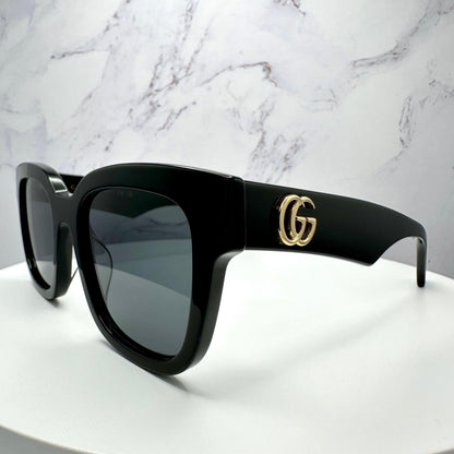 Gucci GG0998S 001 black temple arm sunglasses with gold metal side logo and grey lens