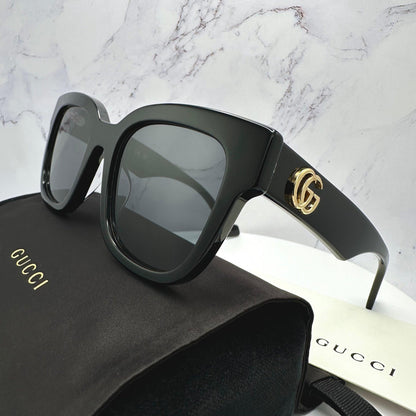 Gucci GG0998S 001 authentic sunglasses with gold metal GG logo grey lens.