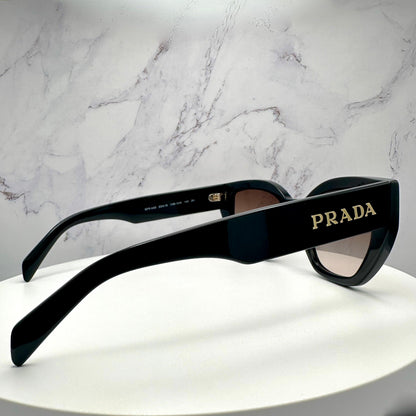 PRADA PRA09S 1AB0A6 black sunglasses with gold metal letter logo side view.