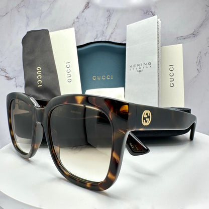 Gucci GG1338S brown tortoise square sunglasses with gold lens.