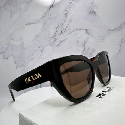 PRADA PRA09S 16N5Y1 brown tortoise cat eye sunglasses with gold logo side view.