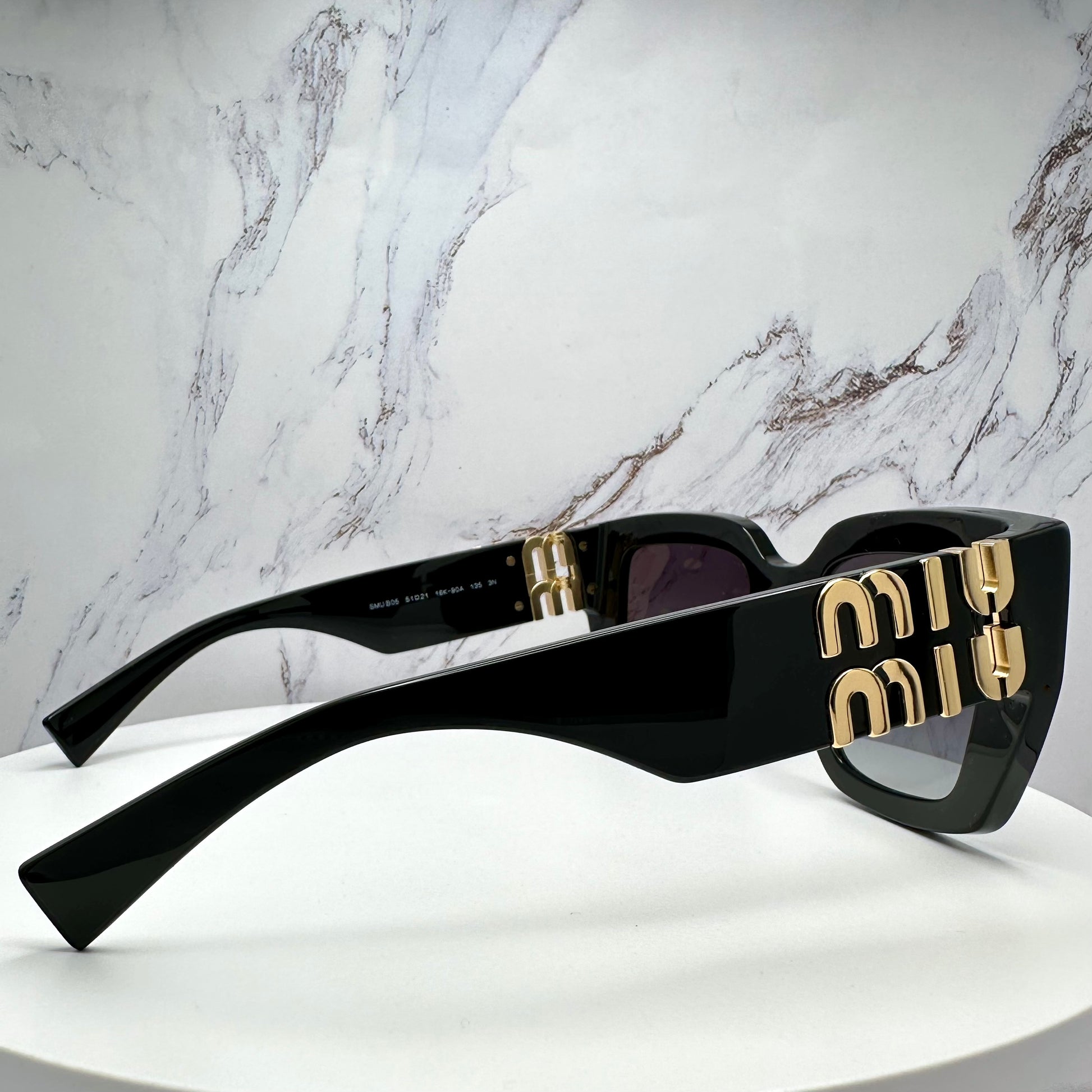 Miu Miu black MUB05S sunglasses with gold logo side view 