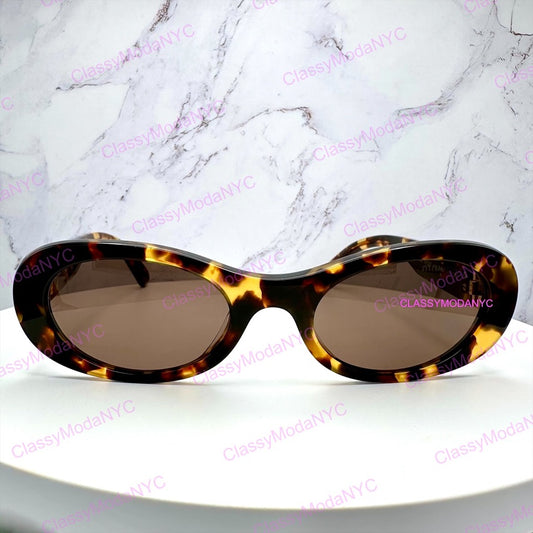 MU 06ZS VAU06B Tortoiseshell sunglasses on a white surface with a marble background