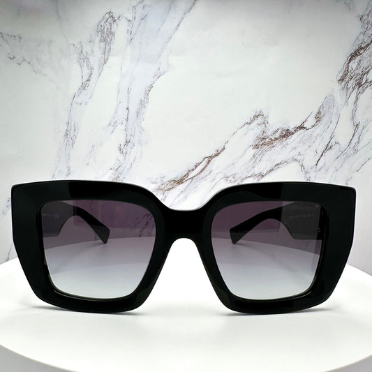 MUB05S 16K90A Miu Miu black sunglasses with gold accents front view 