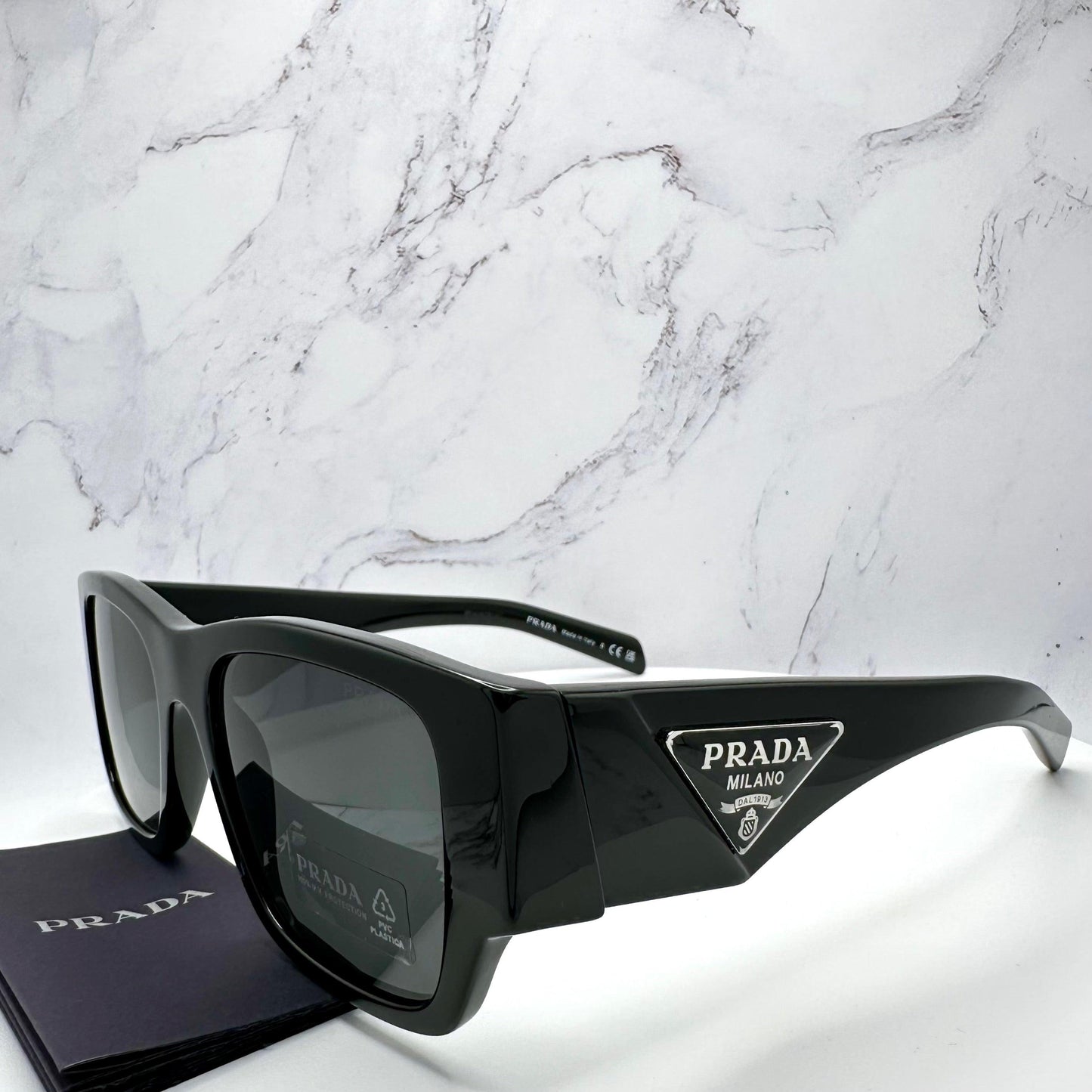 Prada 0PR10ZS 1AB5S0 triangle plaque logo sunglasses.