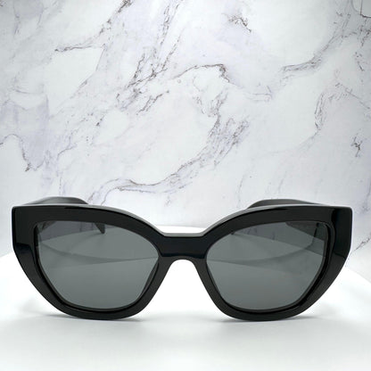PRADA PRA09S 1AB5S0 black cat eye butterfly women’s sunglasses with gray solid lenses, silver Prada lettering and acetate frame.