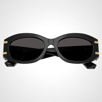 Dolce & Gabbana 0DG4502 501/87 black oval women's sunglasses with grey lens gold logo front facing.