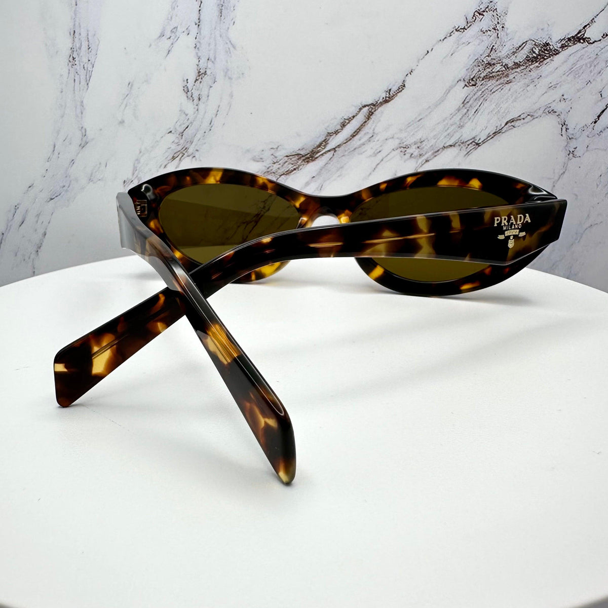Prada PR26ZS 14L09Z women's brown sunglasses back view with brown lens.