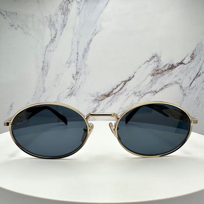 Prada 0PR65ZS ZVN09T gold metal oval sunglasses with grey lens front view