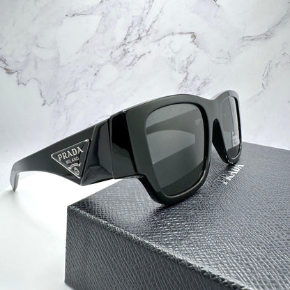 Prada 0PR10ZS 1AB5S0 black square sunglasses with grey lens.