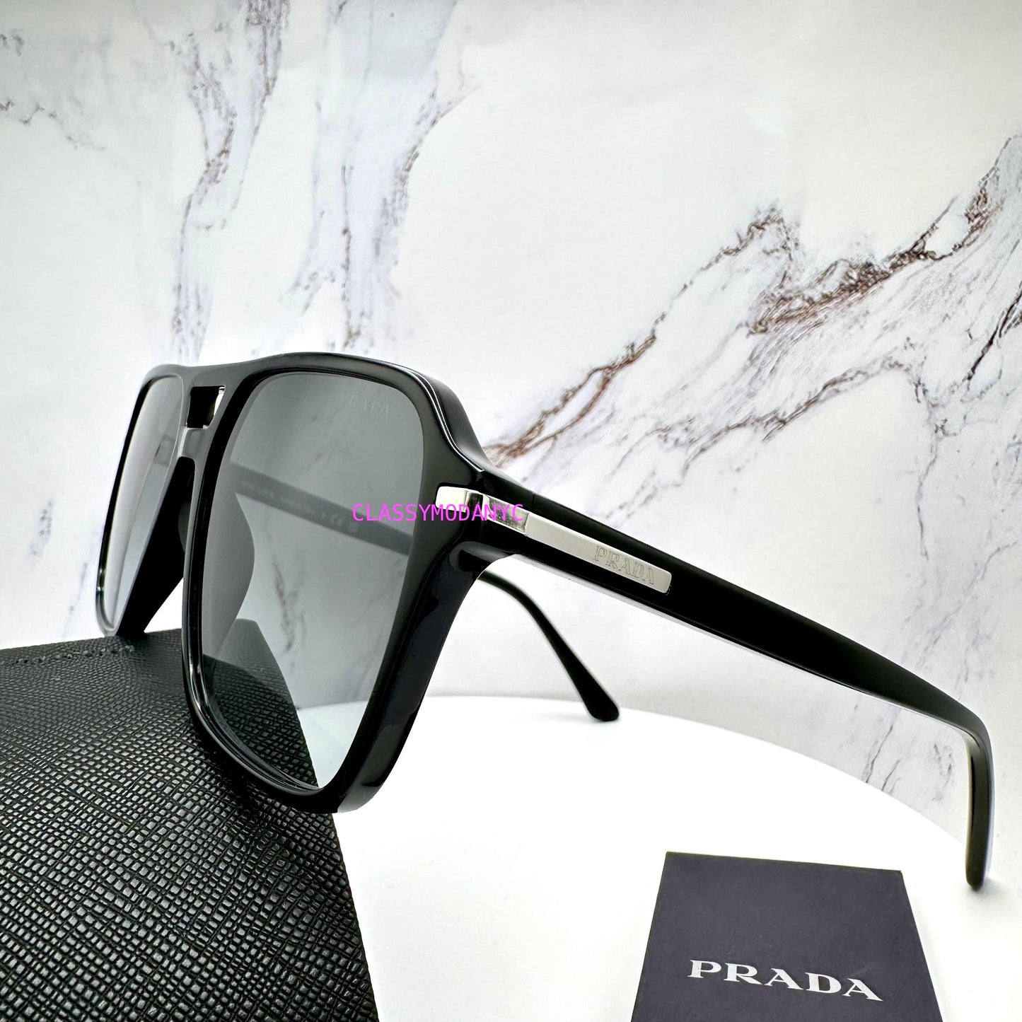 Prada PR20YS 1AB06T black aviator sunglasses with grey lens silver logo side view on Prada case